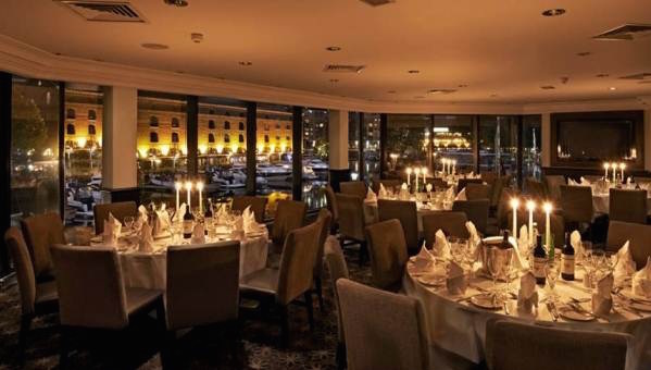 Bridge Suite dressed for a Christmas party with round tables and candles with a view of london Tower Hotel Christmas Party E1