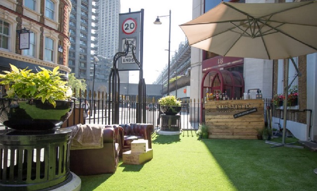 Sipsmith Terrace with parasols, astro turf and chester field sofas Jugged Hare Summer Party EC1