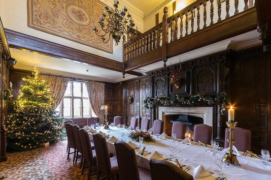 Billesley Manor Hotel Christmas Party B49, Double height ceiling with wooden balcony large banqueting table laid for Christmas