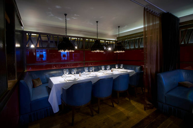 Poet's Corner set for a private dinner with smart blue leather chairs and low lighting hung above the table Corrigan's Mayfair Venue Hire W1