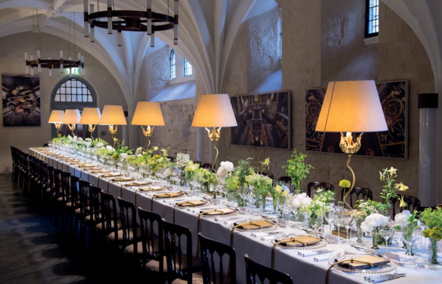 Cellarium set for banquet with long tables dressed with lamps and flowers Westminster Abbey Venue Hire SW1