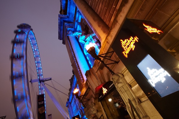 Exterior view with london eye in the background and blue up lighters on the building London Dungeon Venue Hire SE1