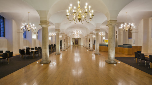 Queen Mary with no furniture in it just view of the large space with shiny wooden floors and large pillars between arch in the ceiling Undercroft Old Royal Naval College Venue Hire SE10