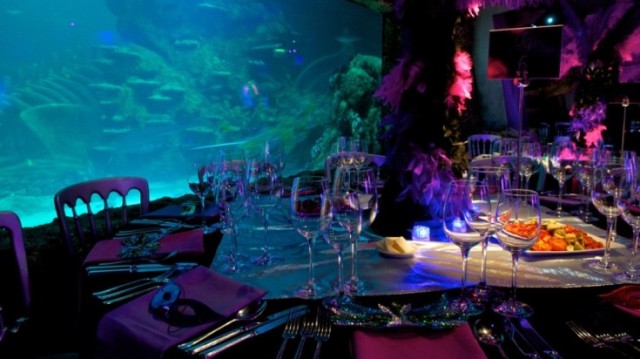 Atlantic Cove set for a formal dinner with round tables set for dinner with live aquarium in the background London Aquarium Venue Hire SE1