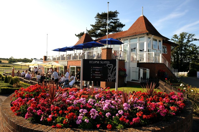 External View of the Eclipse Suites with views of the racecourse with colourful flowers blooming in front of the building Lingfield Park Hotel & Country Club Summer Party RH7